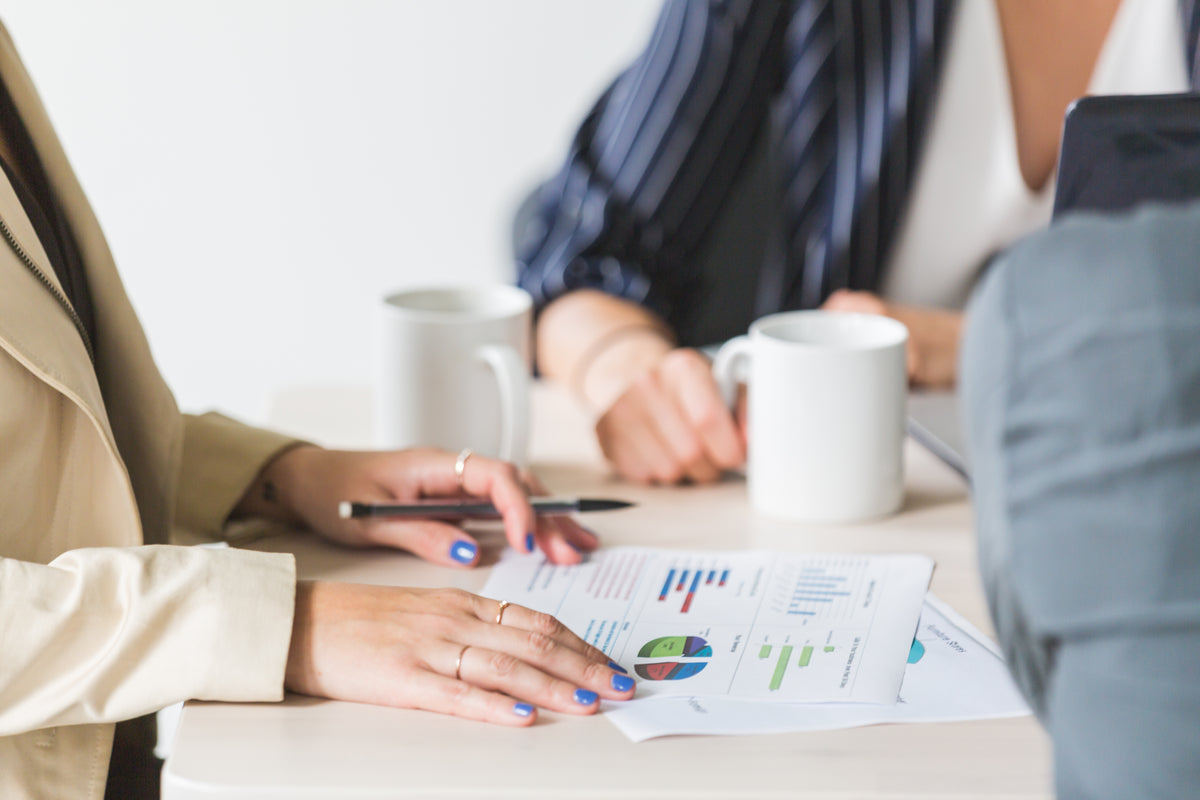 People reviewing printed charts and data at a table