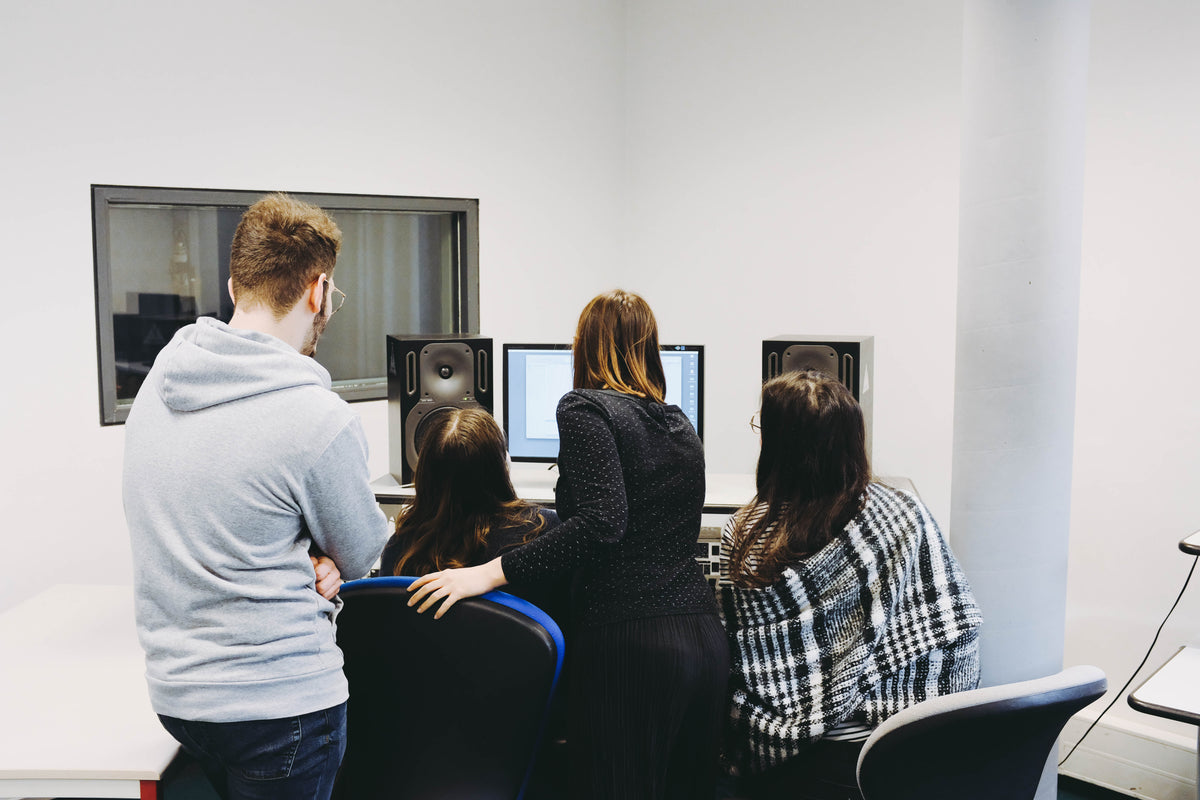 IT staff working together at computer workstations