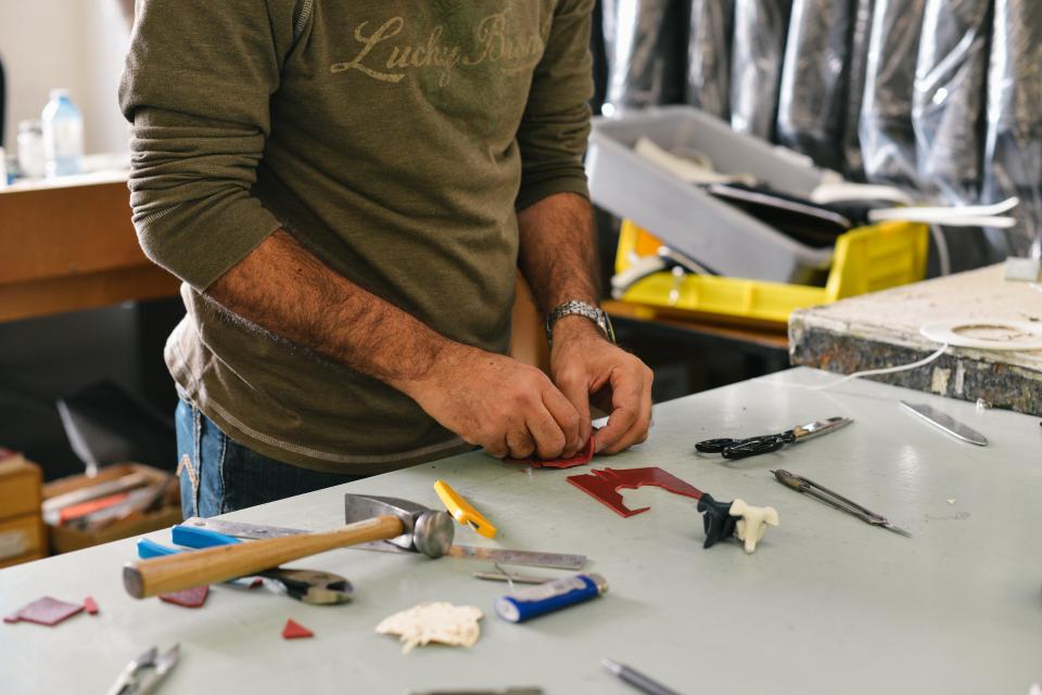 An operative assembling parts at a workbench