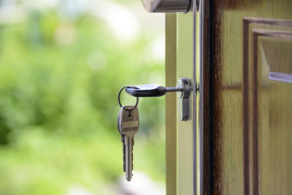 A set of keys in an open front door
