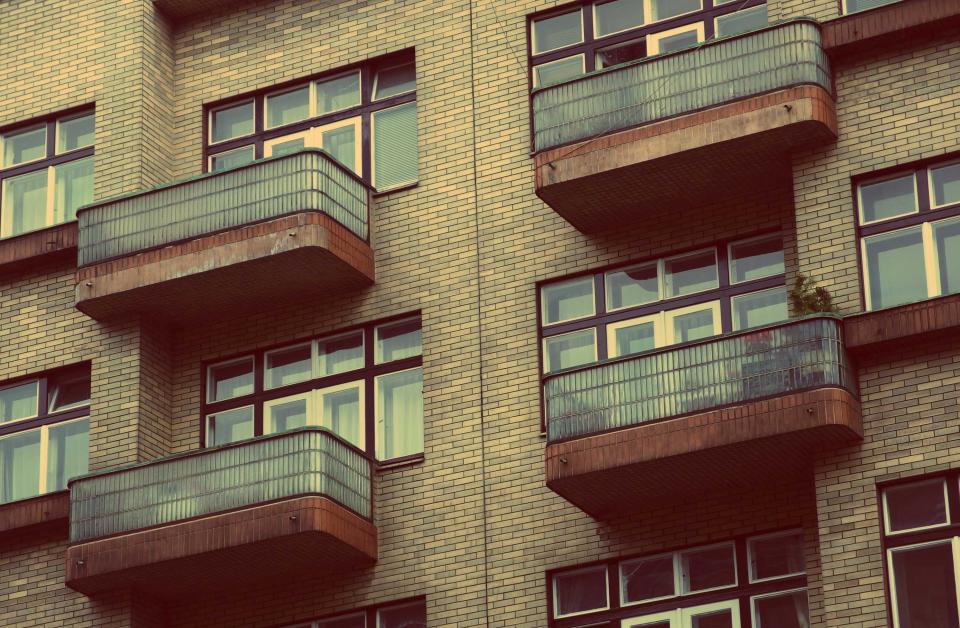 A brick apartment block with balconies